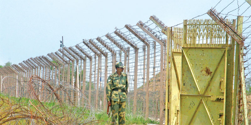 Security personnel guarding fence