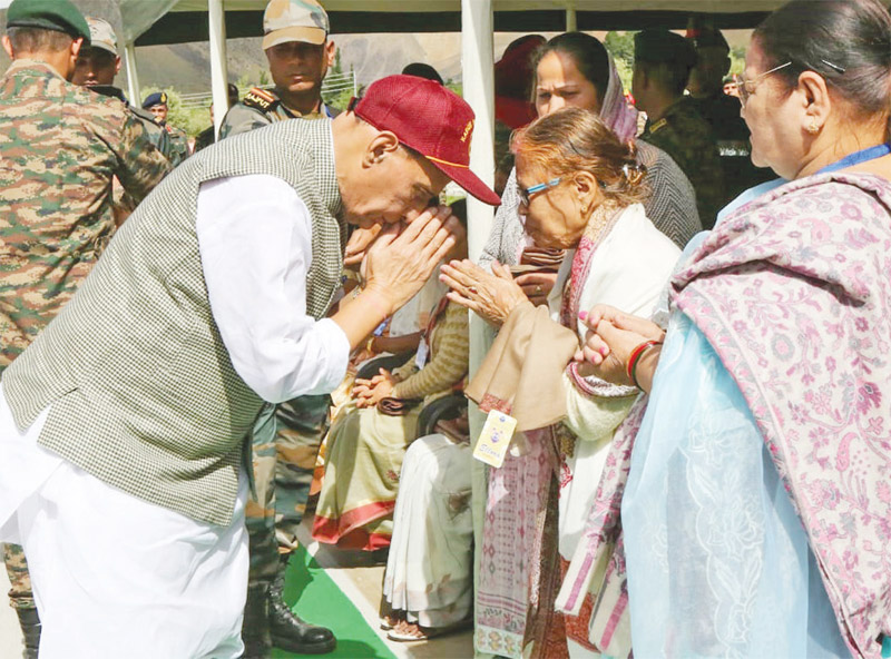 Defence minister Rajnath Singh with a Veer Nari