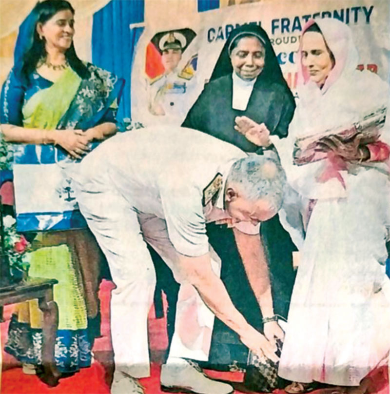 Adm. R. Hari Kumar with Mrs Kala Nair touching the feet of his old class teacher Jameela Beevi as school director Sr Renita looks on